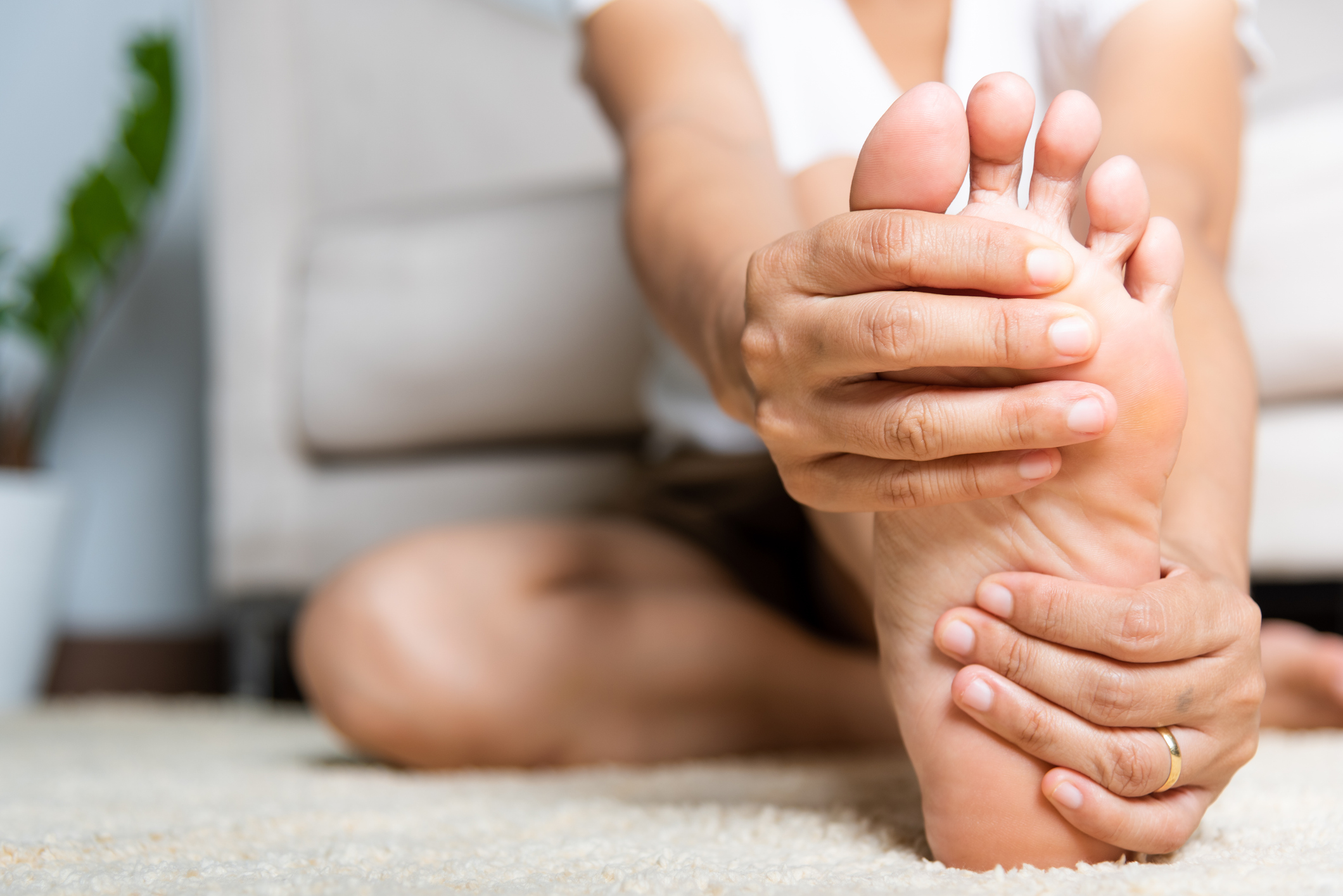 Image showing someone holding their foot due to pain